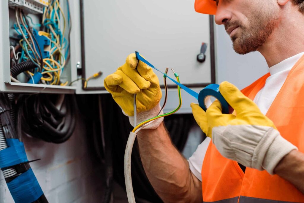 cropped-view-of-electrician-using-insulating-tape-while-fixing-wires-of-electric-panel.jpg